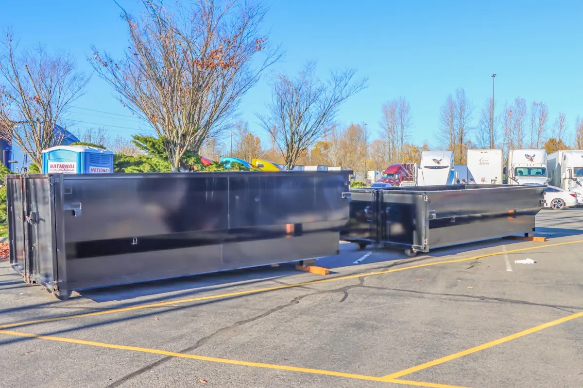 Professional dumpster rental service with roll-off container on residential driveway in Cedarhurst